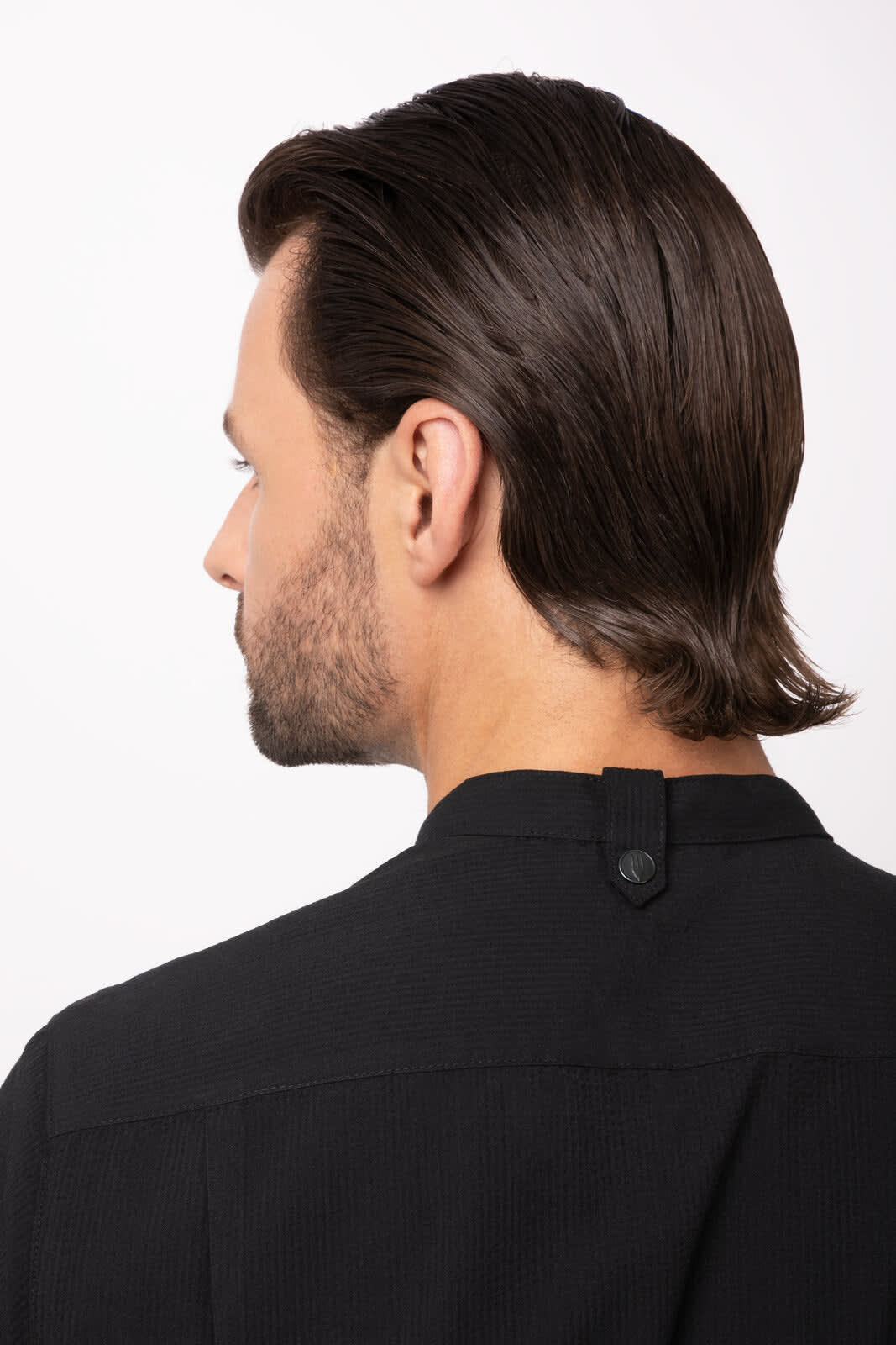 A black seersucker men's button-up shirt, featuring a button detail at the back neckline.