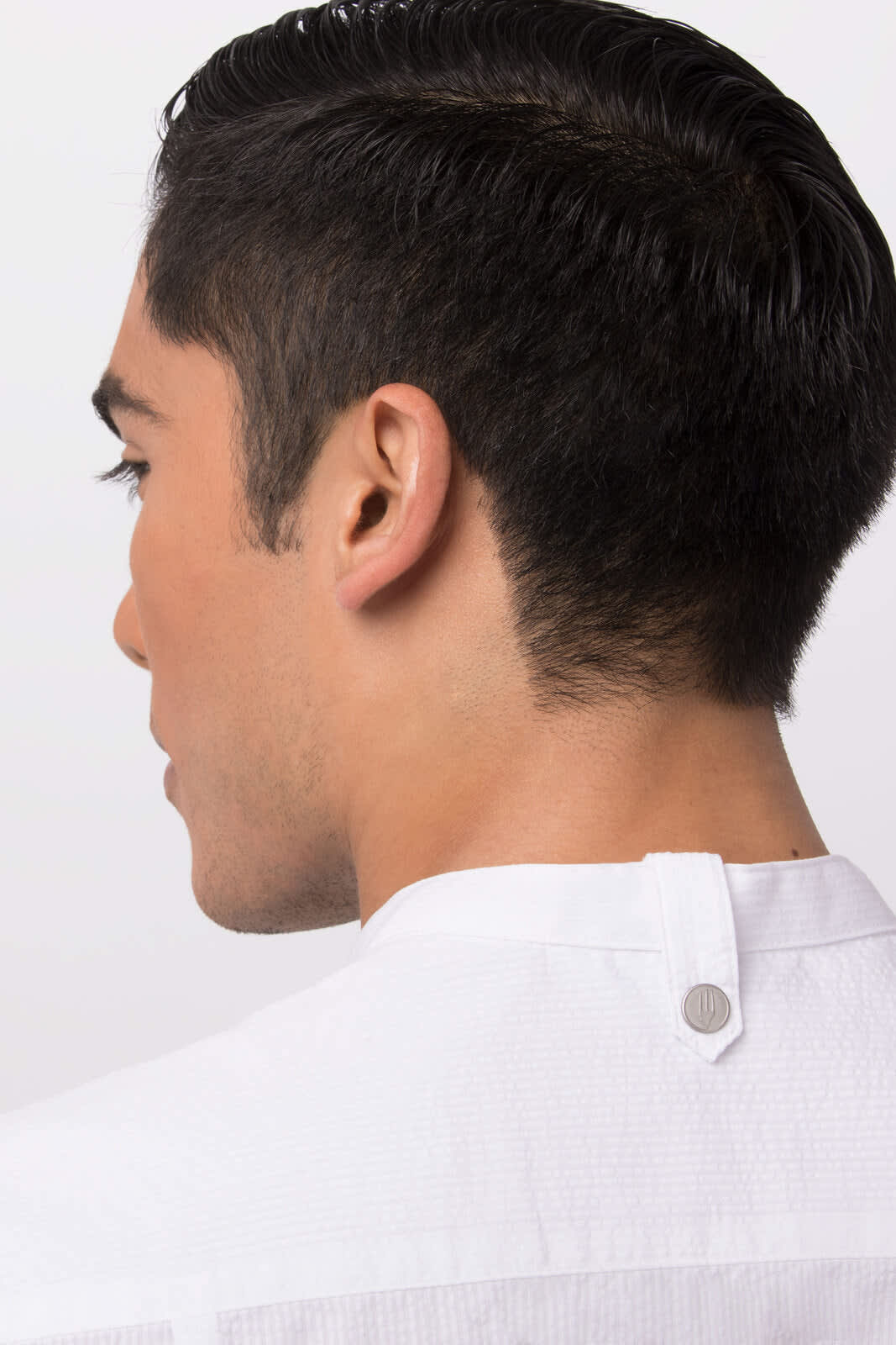 A Seersucker men's shirt in white featuring a button at the back, displayed on a model's upper back and neck.