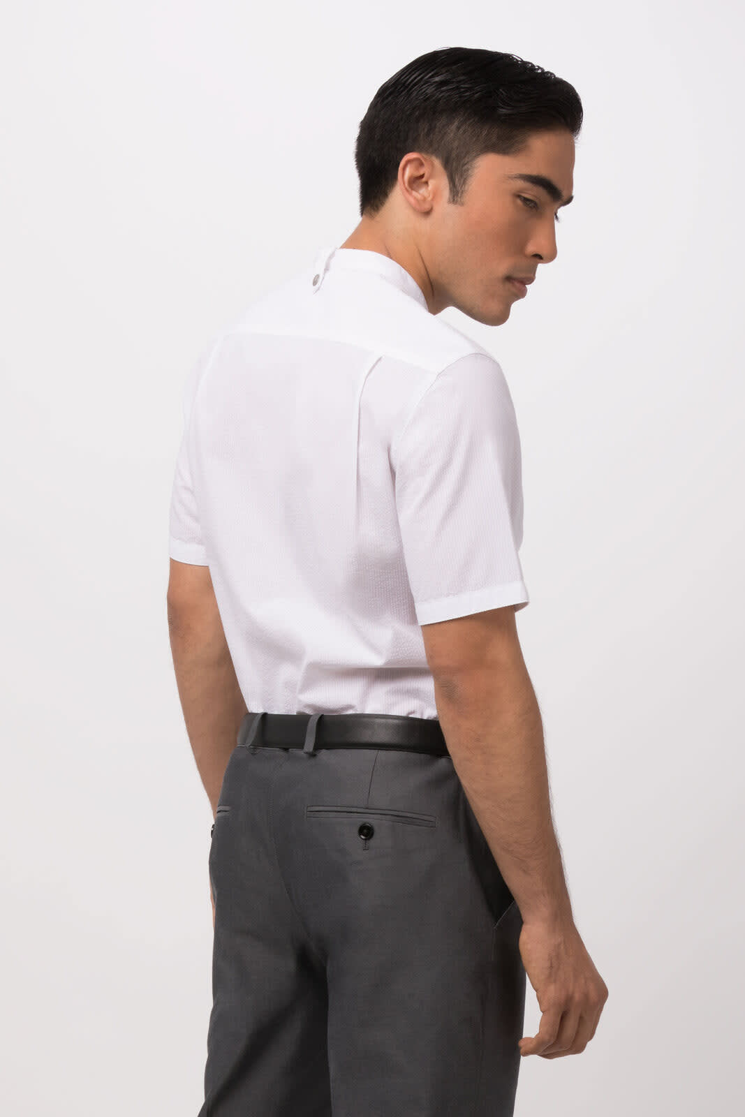 A white seersucker men's shirt displayed from the back, paired with grey trousers, featuring a branding logo.