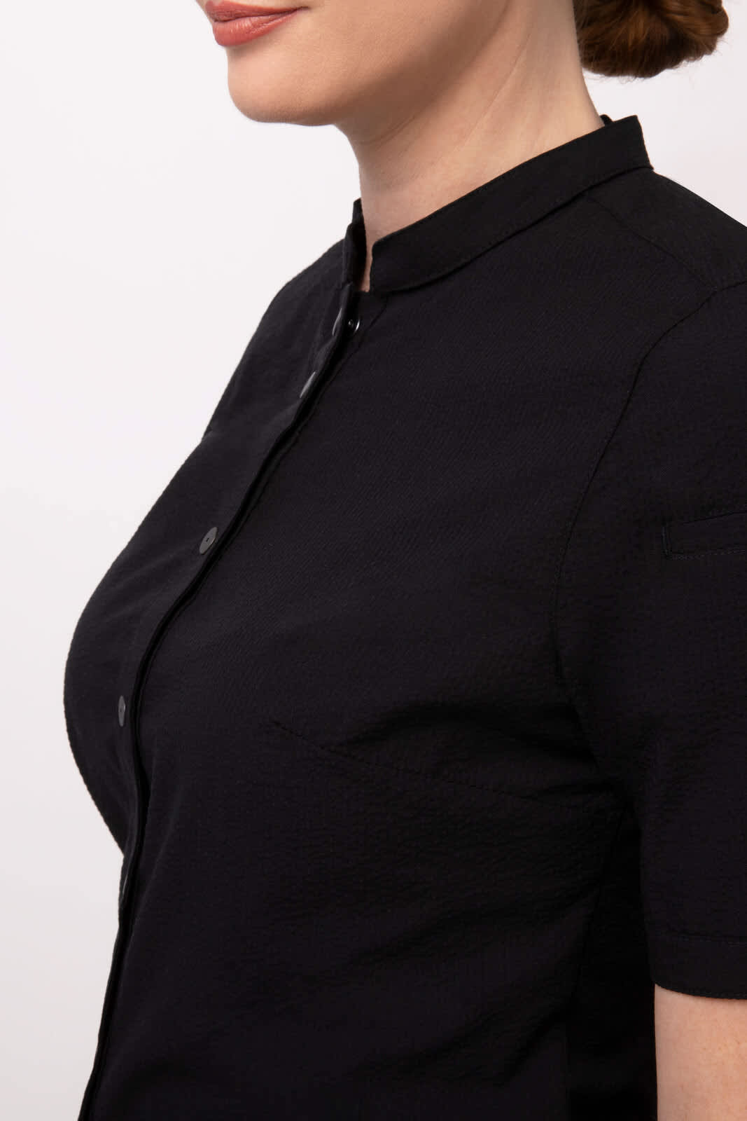 A black Seersucker women's button-up shirt with a collar and short sleeves. It features a simple design and has buttons.