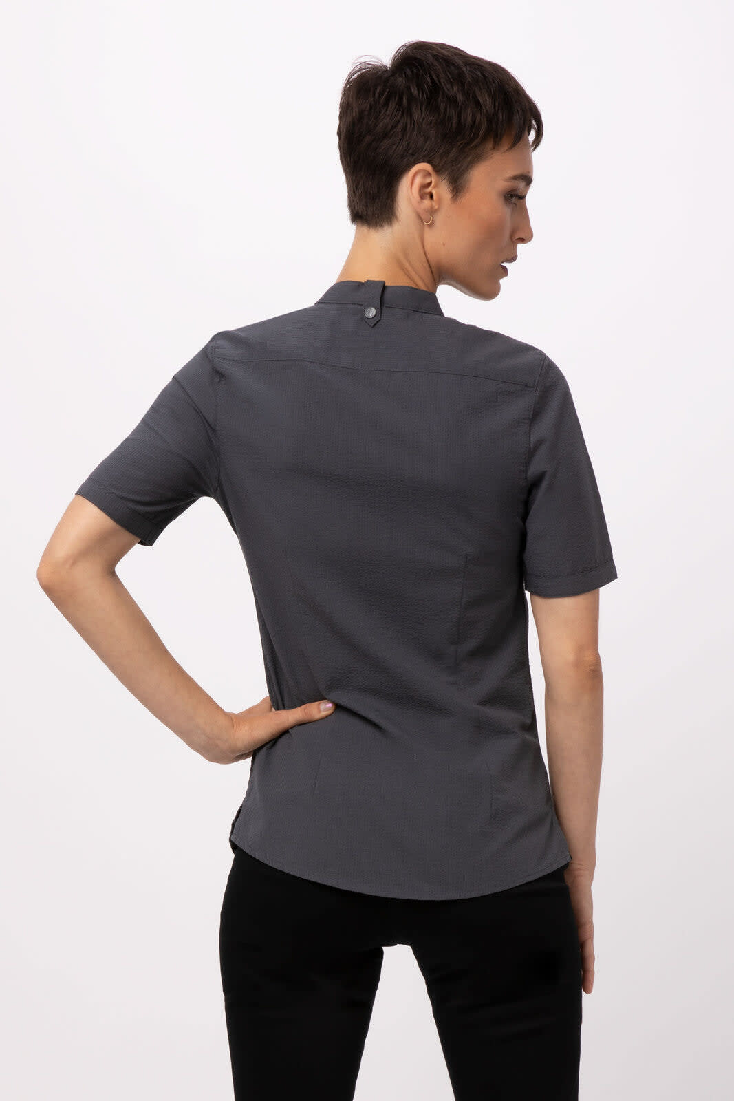 A grey seersucker women's shirt with short sleeves, featuring a high collar and a button closure at the back.