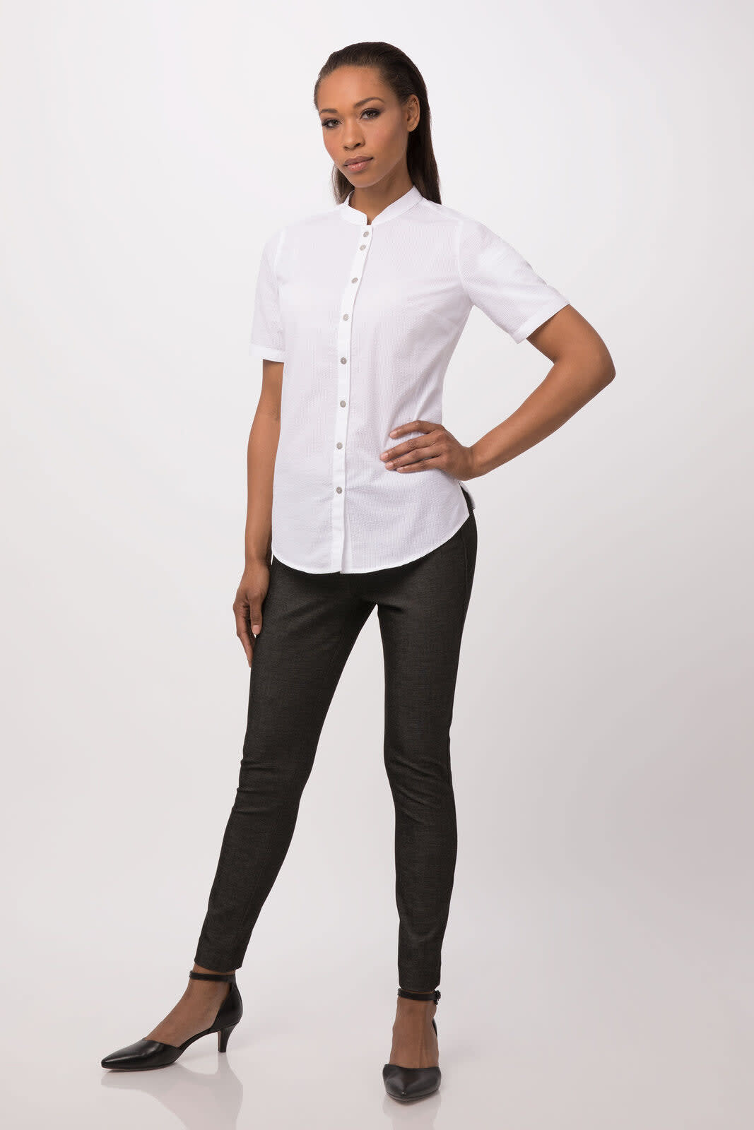 A white button-up women's shirt with short sleeves, paired with black fitted trousers and heels.