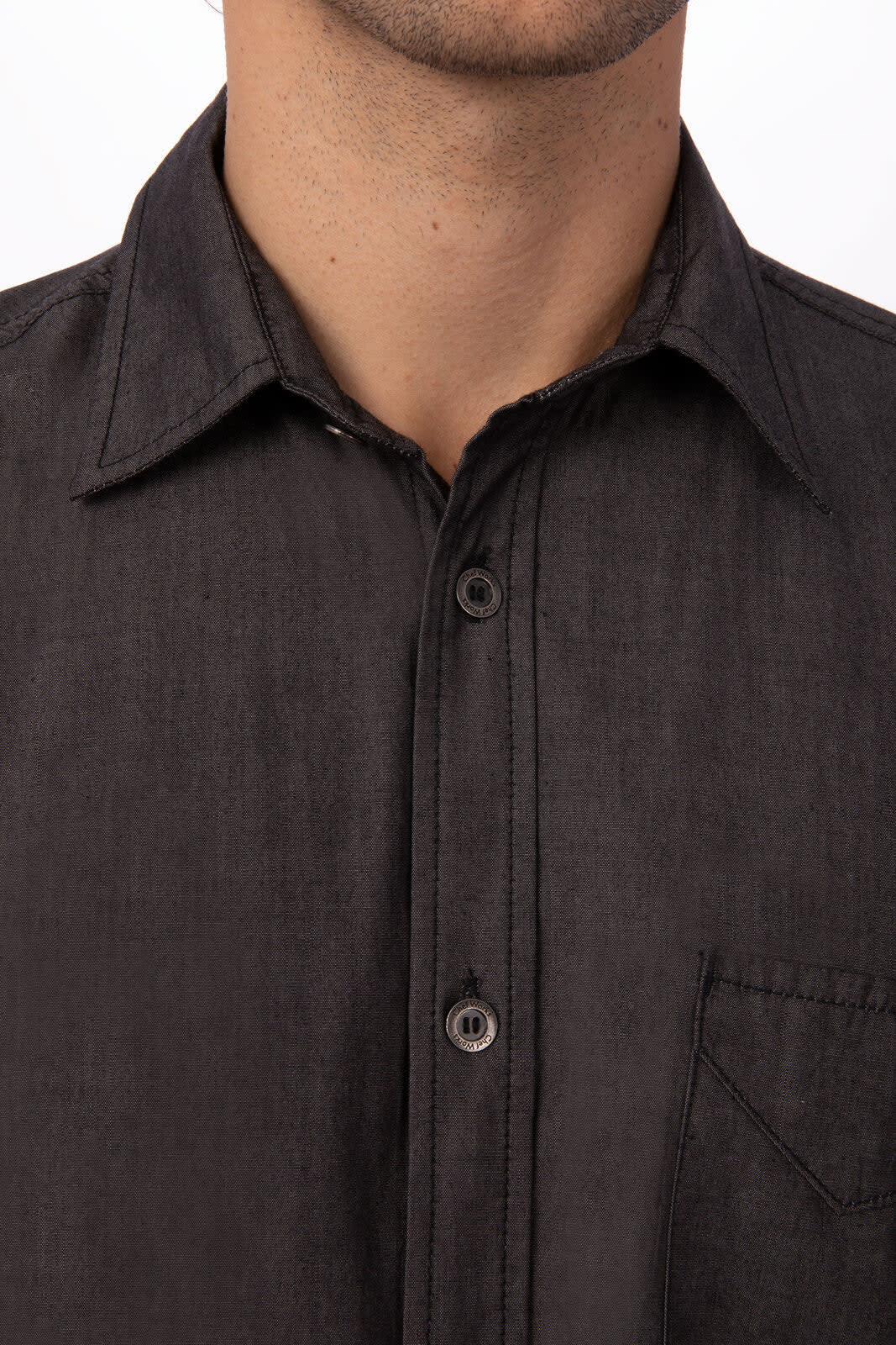 A black short sleeve denim shirt with a button-up front and a chest pocket, featuring a collar and branding.