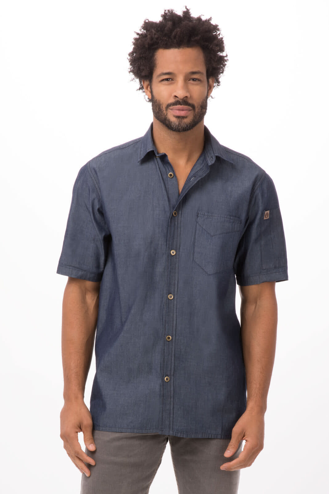 A denim button-up shirt in dark blue, featuring short sleeves and a chest pocket, with a logo on the sleeve.