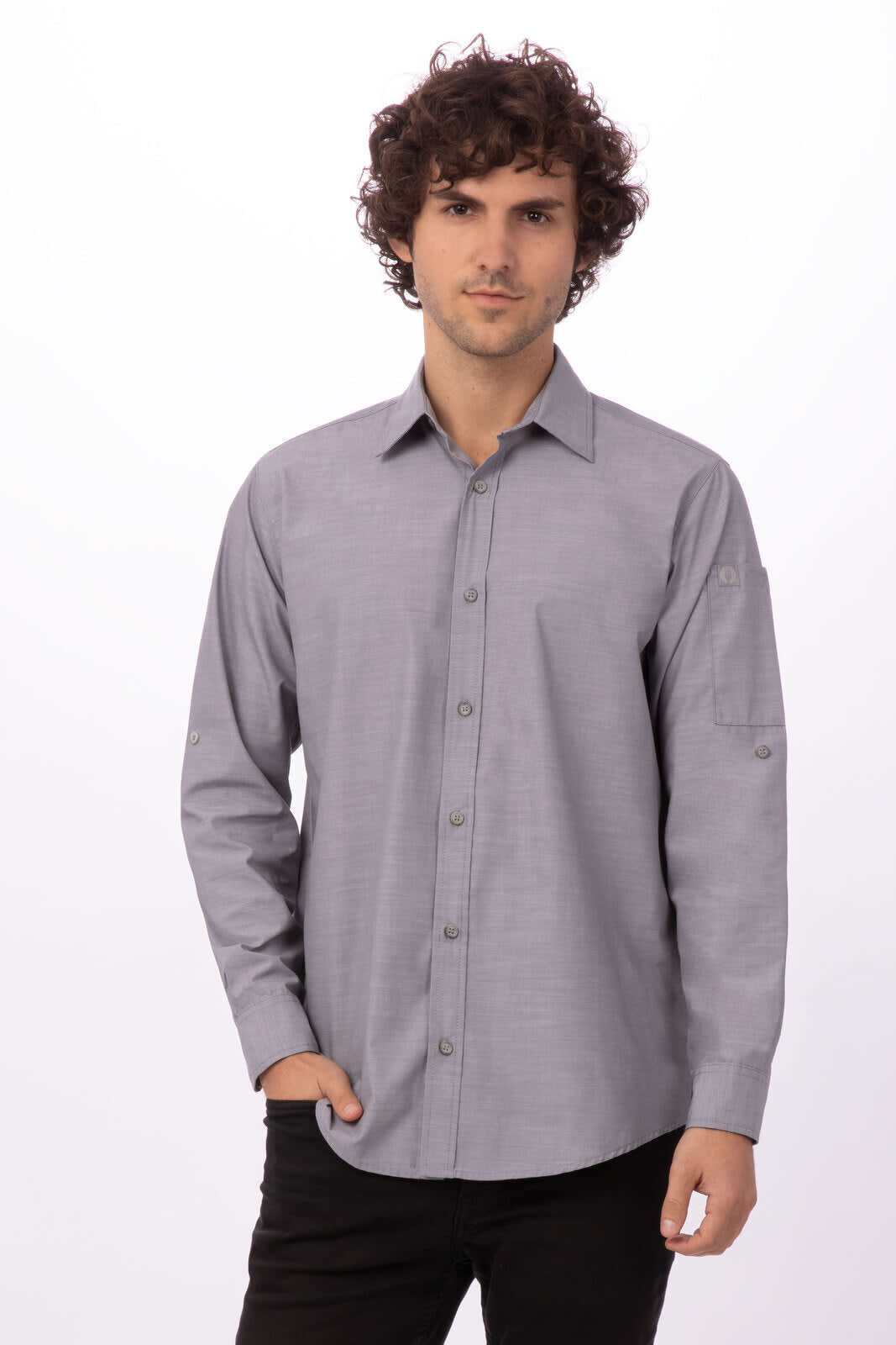 A grey chambray button-up shirt on a mannequin, featuring long sleeves and a collar. The shirt has a logo.