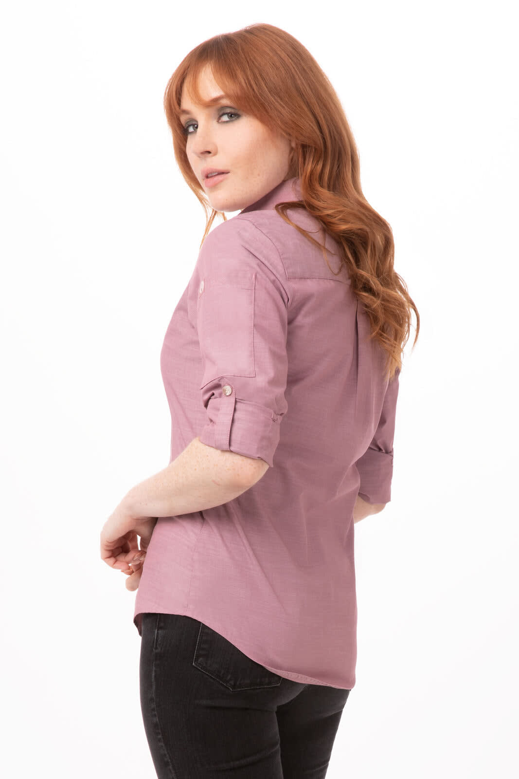 A women's chambray shirt in a soft mauve colour, featuring rolled-up sleeves and a fitted design.
