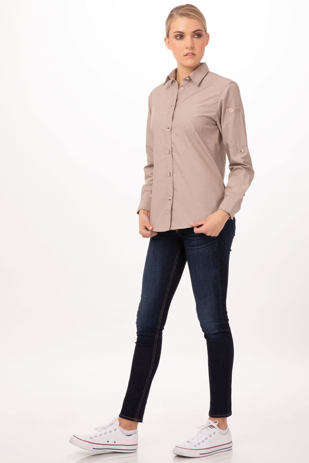 A chambray women's shirt in light brown, featuring a button-up design, paired with dark jeans and white sneakers.