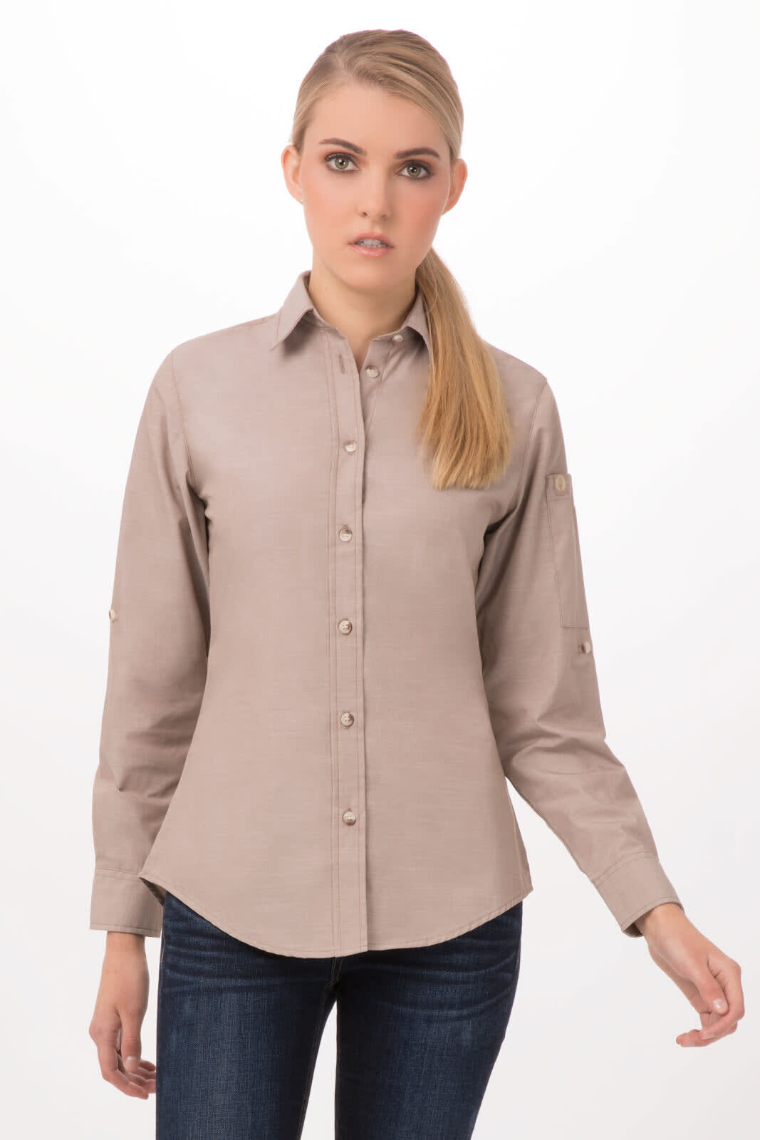 A light brown chambray women's shirt with a collar and buttons, featuring long sleeves and a logo on the side.