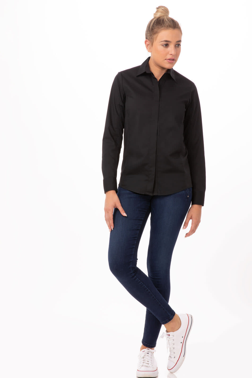 A black button-up shirt with long sleeves, paired with blue jeans and white sneakers. The shirt includes a logo.