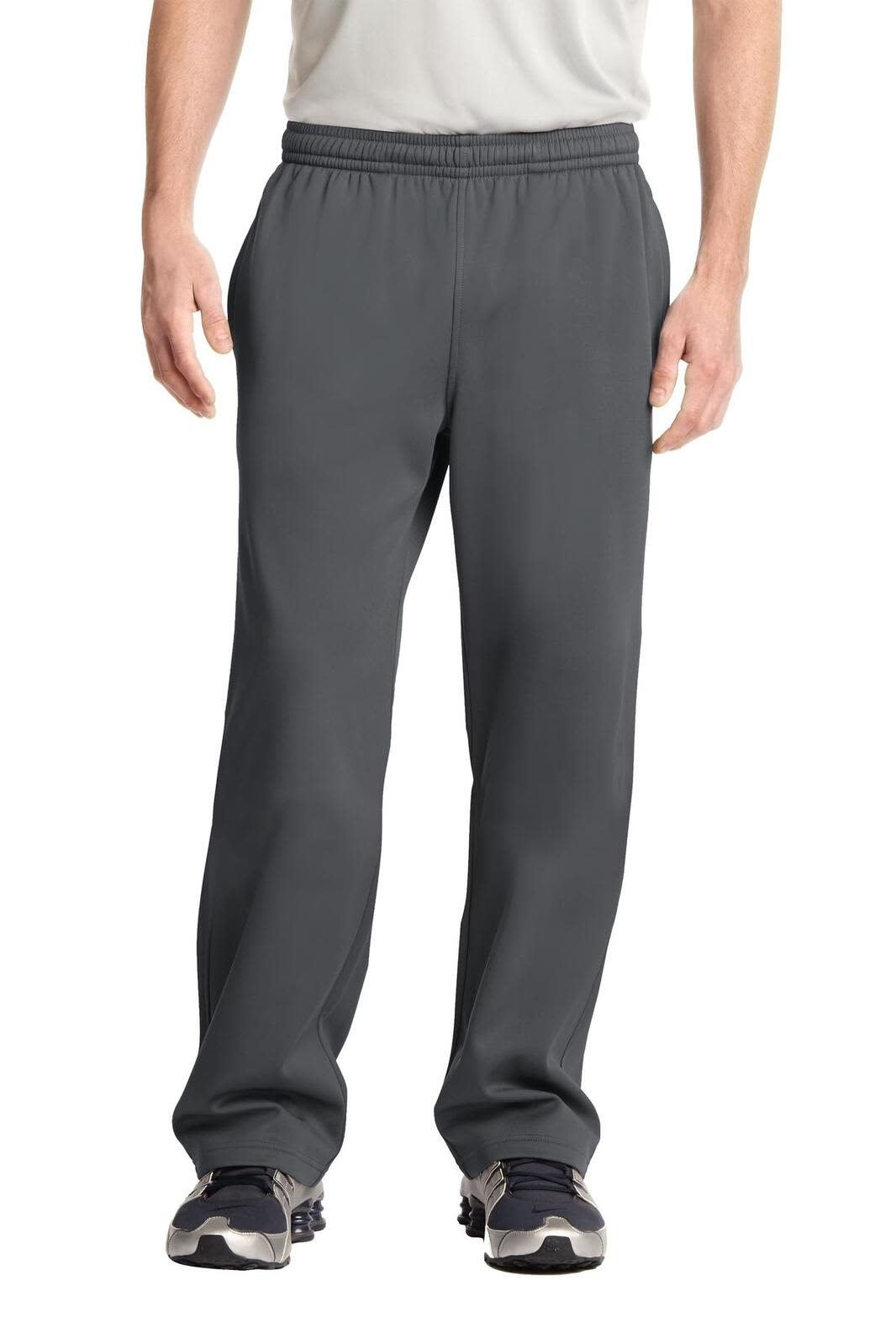 Dark grey track pants with an elastic waistband, featuring a logo on one side. Designed in a relaxed fit.