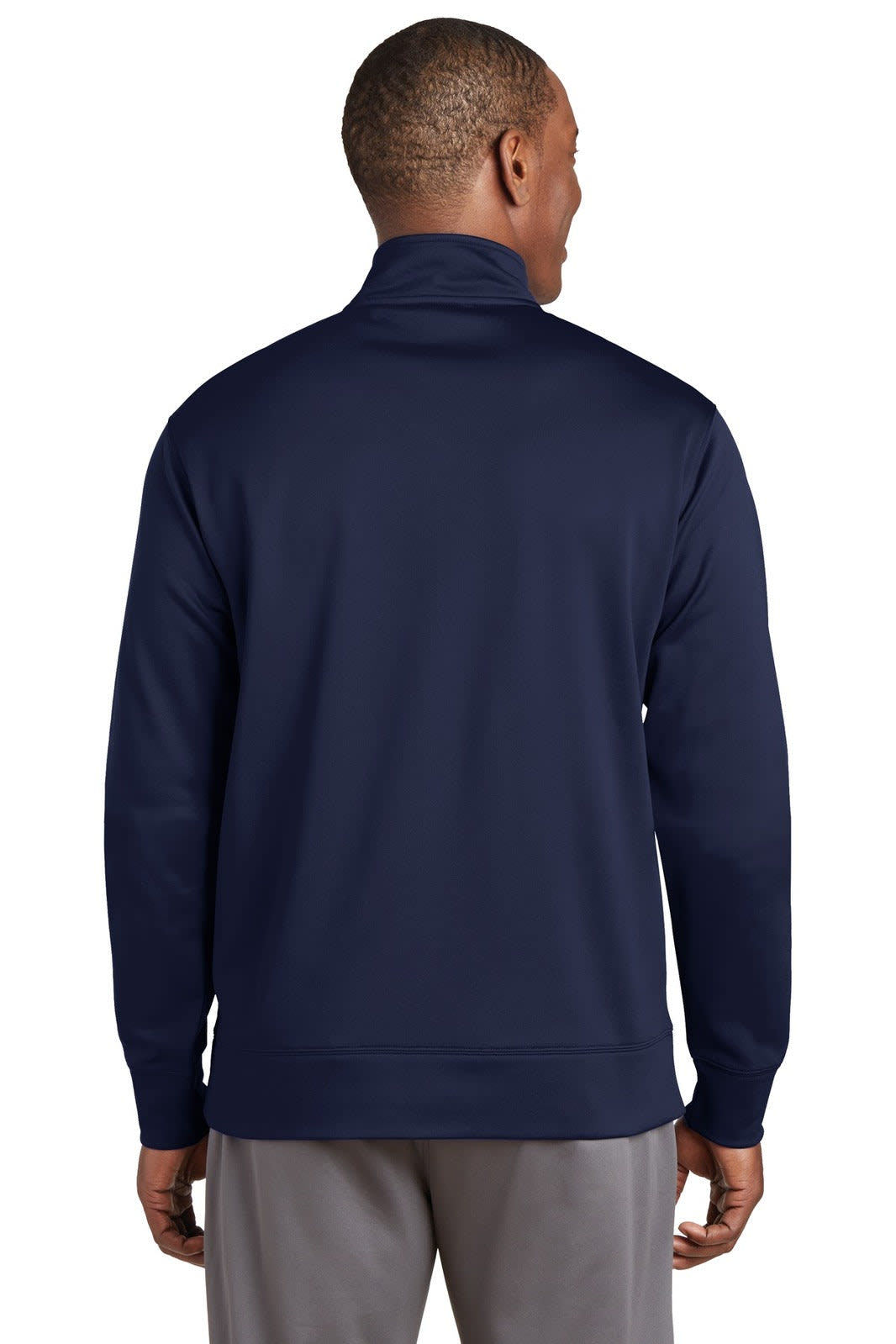 A man wearing a navy blue Sport-Tek Sport-Wick Fleece Full-Zip Jacket, shown from the back. The jacket features a high collar.