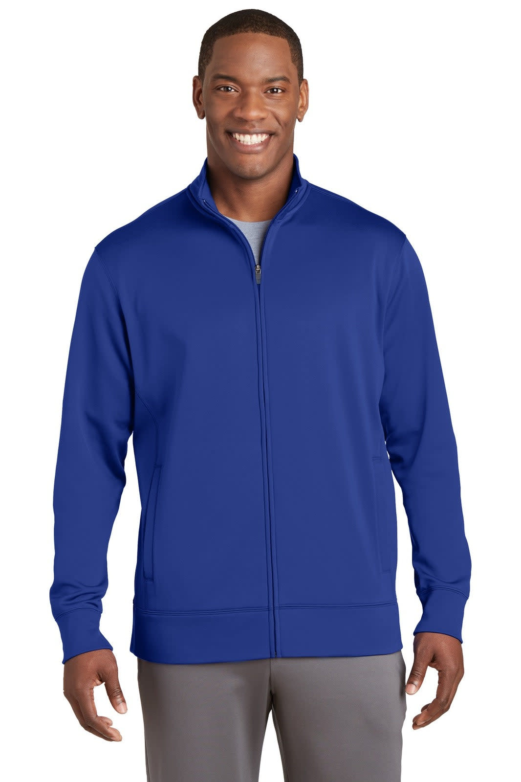 A man wearing a royal blue Sport-Tek Sport-Wick fleece full-zip jacket with a logo on the chest.