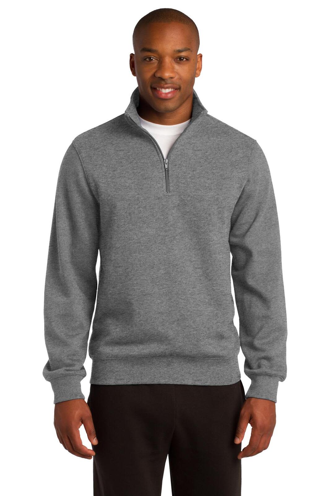 A man wearing a grey Sport-Tek 1/4-zip sweatshirt, standing with hands by his sides. The sweatshirt features a collar and a logo.