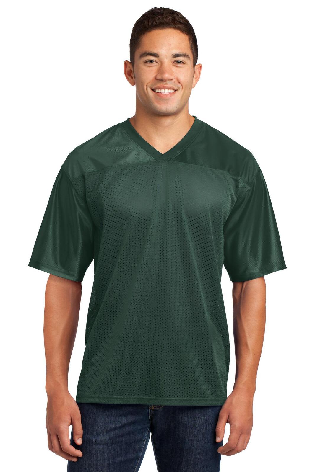 A man wearing a dark green Sport-Tek PosiCharge Replica Jersey, featuring short sleeves and a V-neck design.