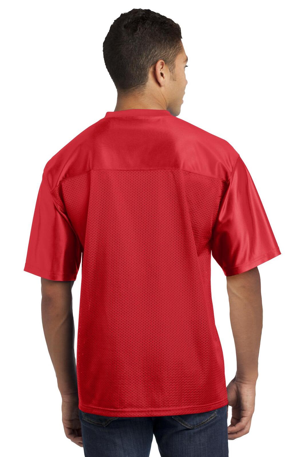 A red Sport-Tek PosiCharge Replica Jersey worn by a person, featuring a back view. The jersey has a logo on it.