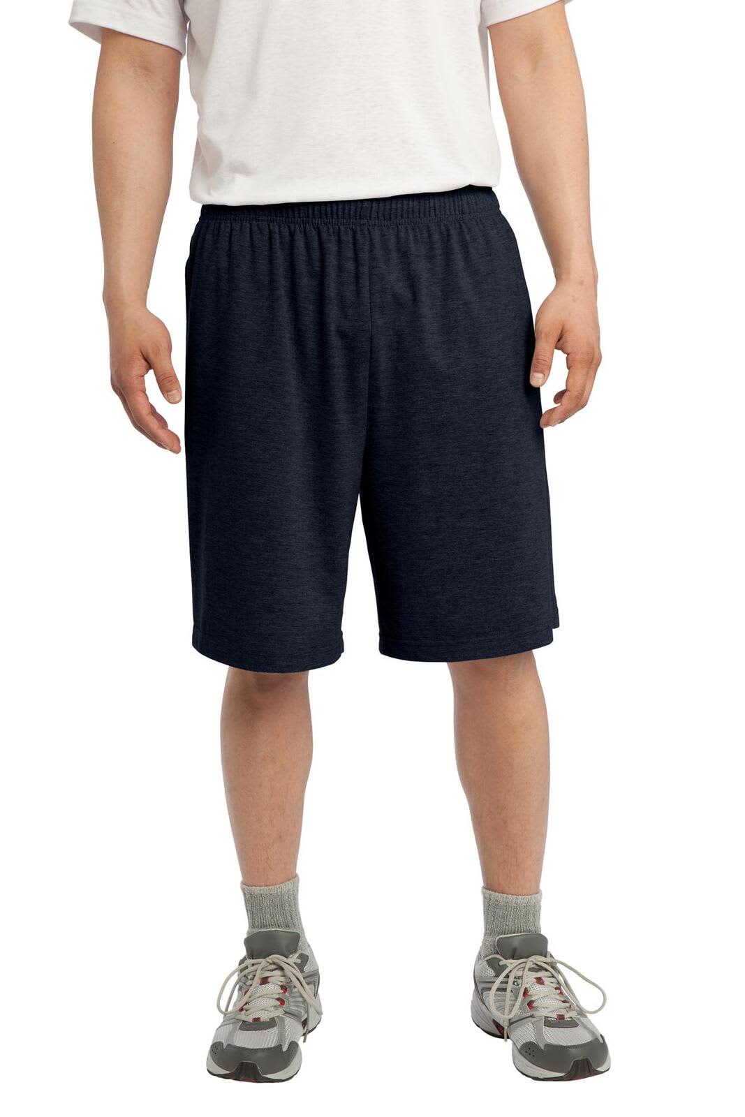 Navy sports shorts with an elastic waistband and pockets, worn by a person standing. Features branding on the garment.