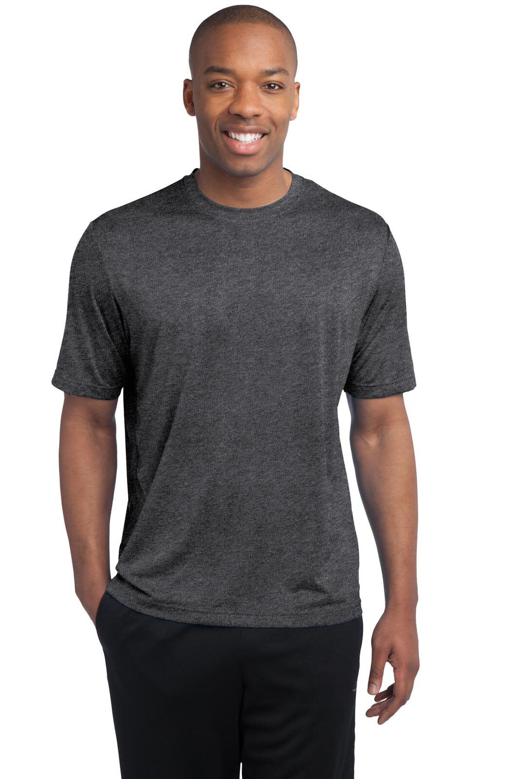 A man wearing a dark heather grey t-shirt, standing and smiling. The shirt features a logo on the front.