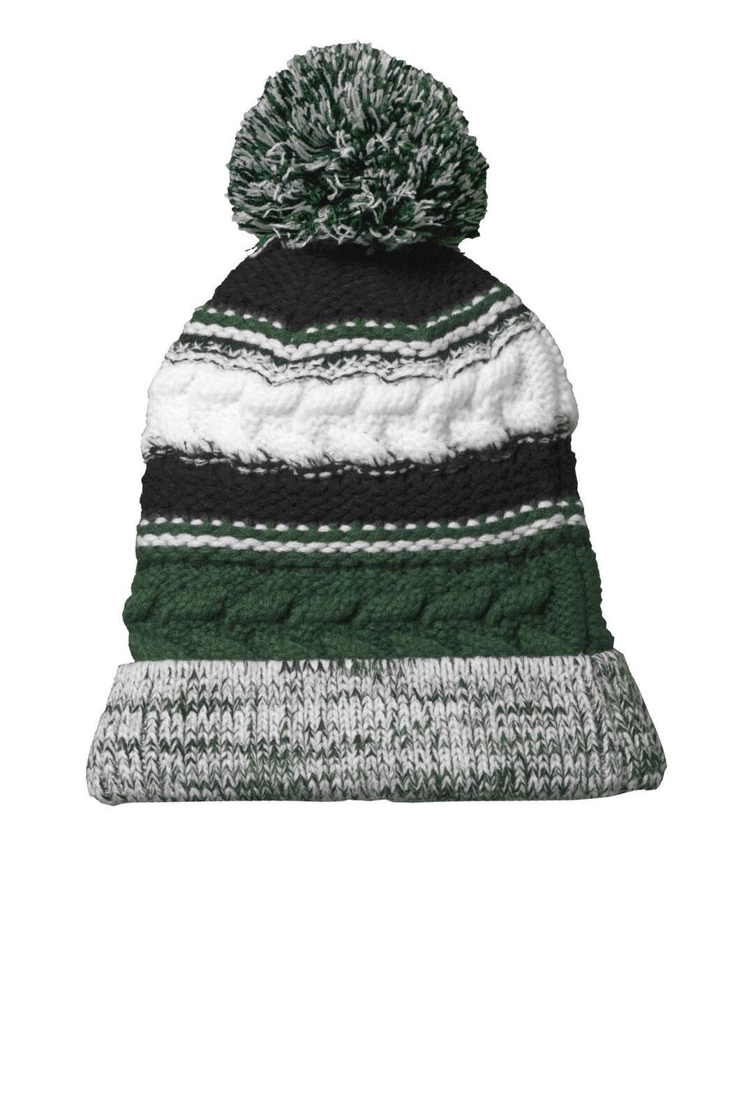 A green, black, and white knitted beanie with a pom pom on top and a textured design.