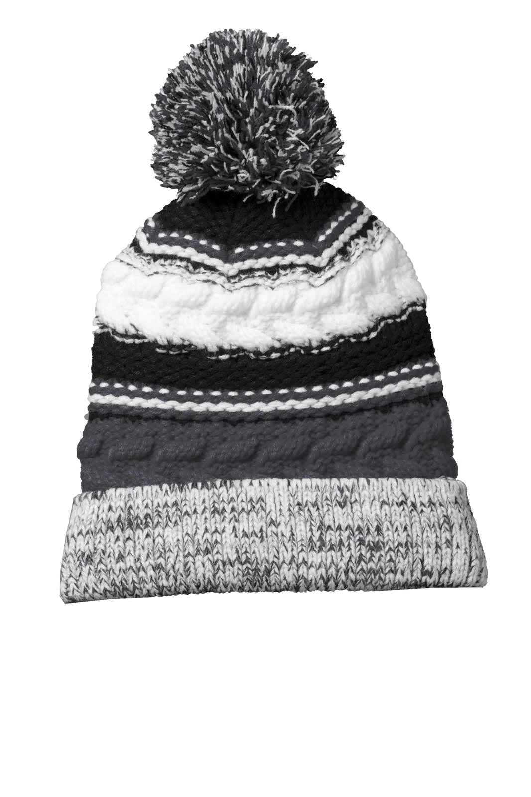 A black, grey, and white patterned beanie featuring a fluffy pom pom on top and a foldable brim.