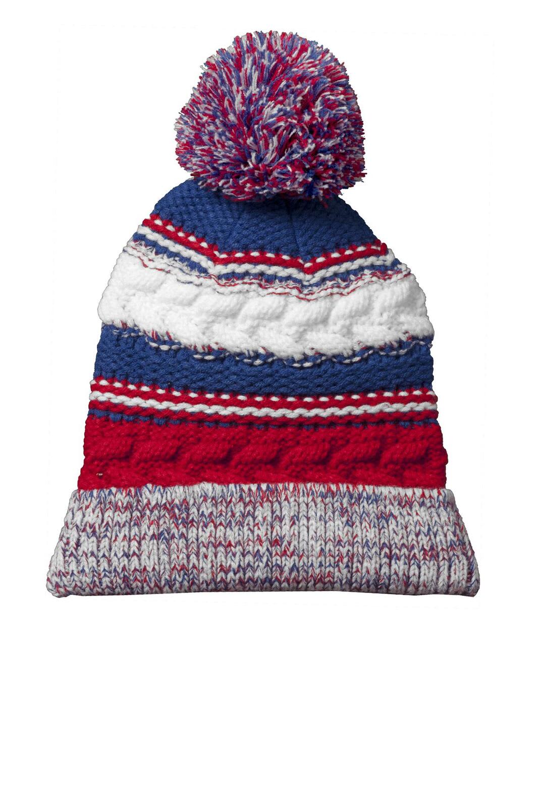 A multicoloured beanie featuring red, white, and blue stripes with a large pom pom on top.