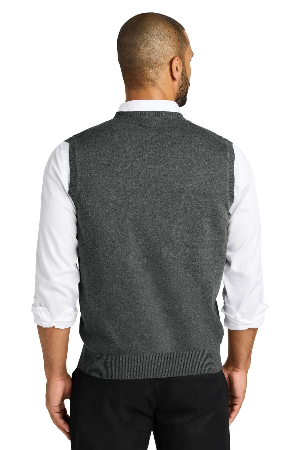 A grey sweater vest viewed from the back, worn over a white collared shirt. Includes a logo on the garment.