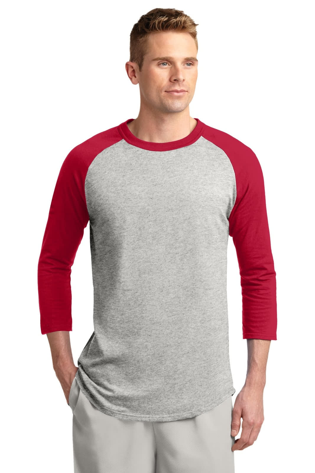 A grey and red Sport-Tek Colorblock Raglan Jersey with three-quarter sleeves worn by a model. Features a logo.
