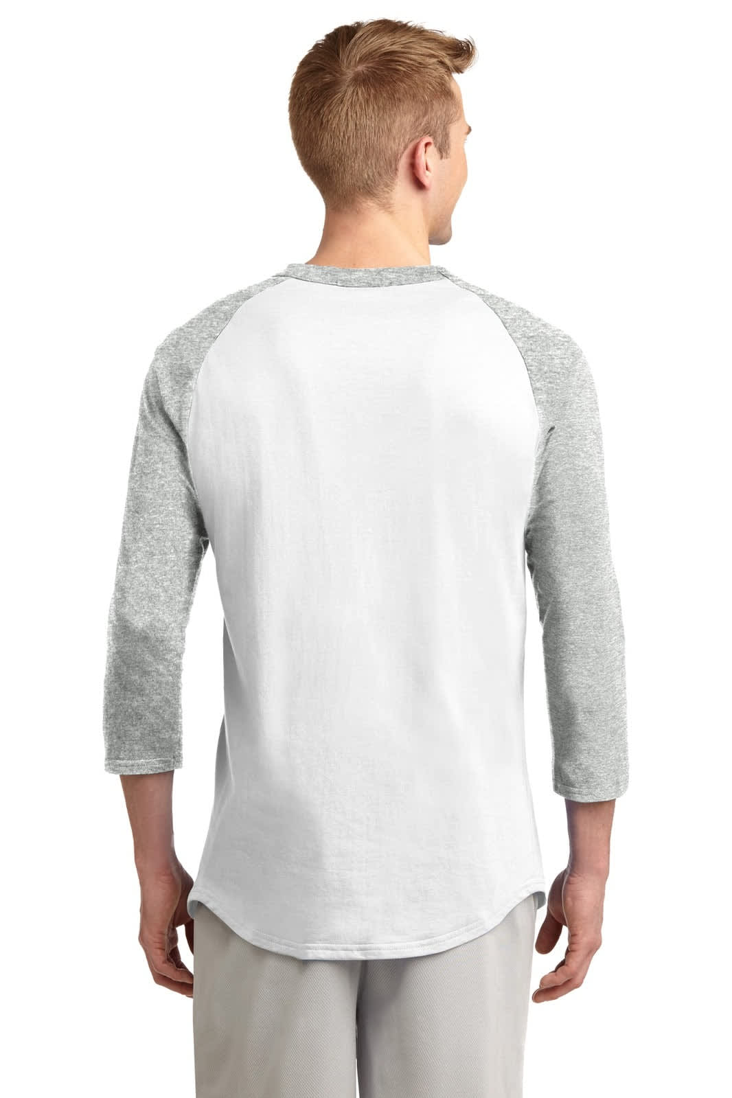 A man in a grey and white Sport-Tek Colorblock Raglan Jersey, viewed from the back. The shirt has three-quarter sleeves and a curved hem.