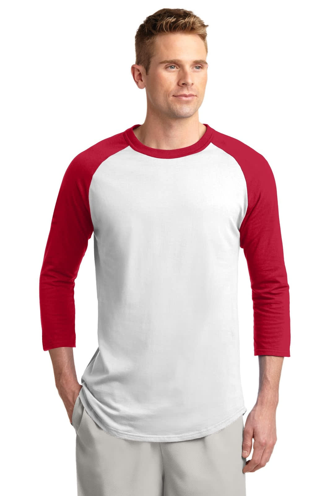 A man wearing a Sport-Tek Colorblock Raglan Jersey in white with red sleeves and a logo on the front.