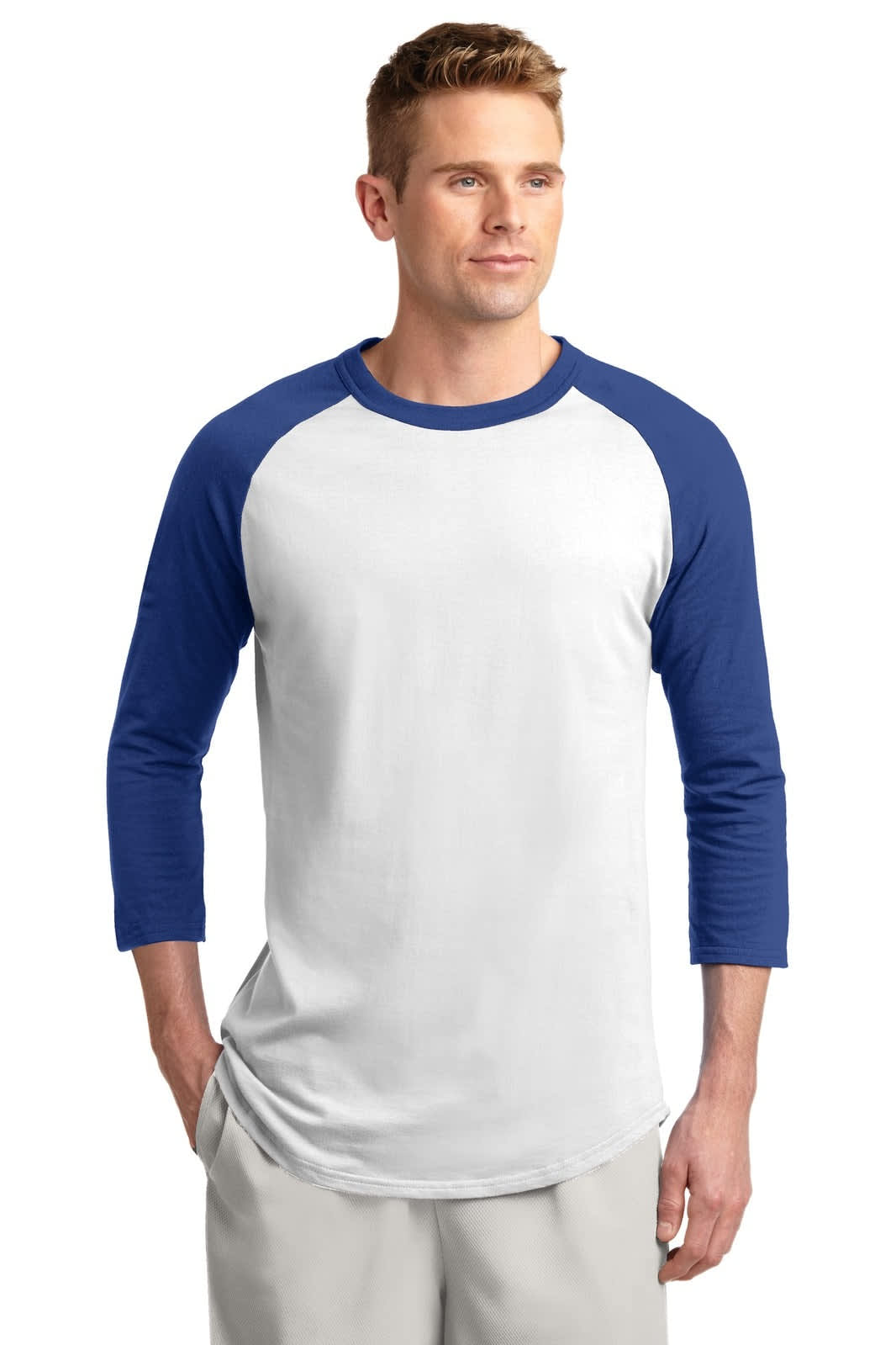 A man wearing a Sport-Tek colourblock raglan jersey in white with blue sleeves. The shirt features a logo.