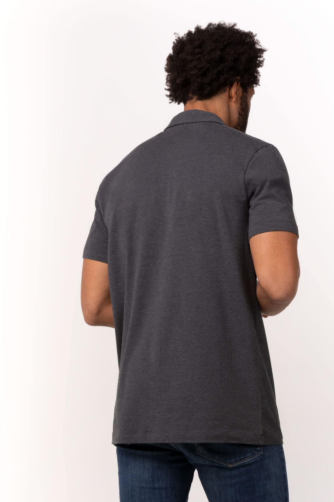 A grey polo shirt with short sleeves and a rear view of a person wearing it. The shirt features a logo.