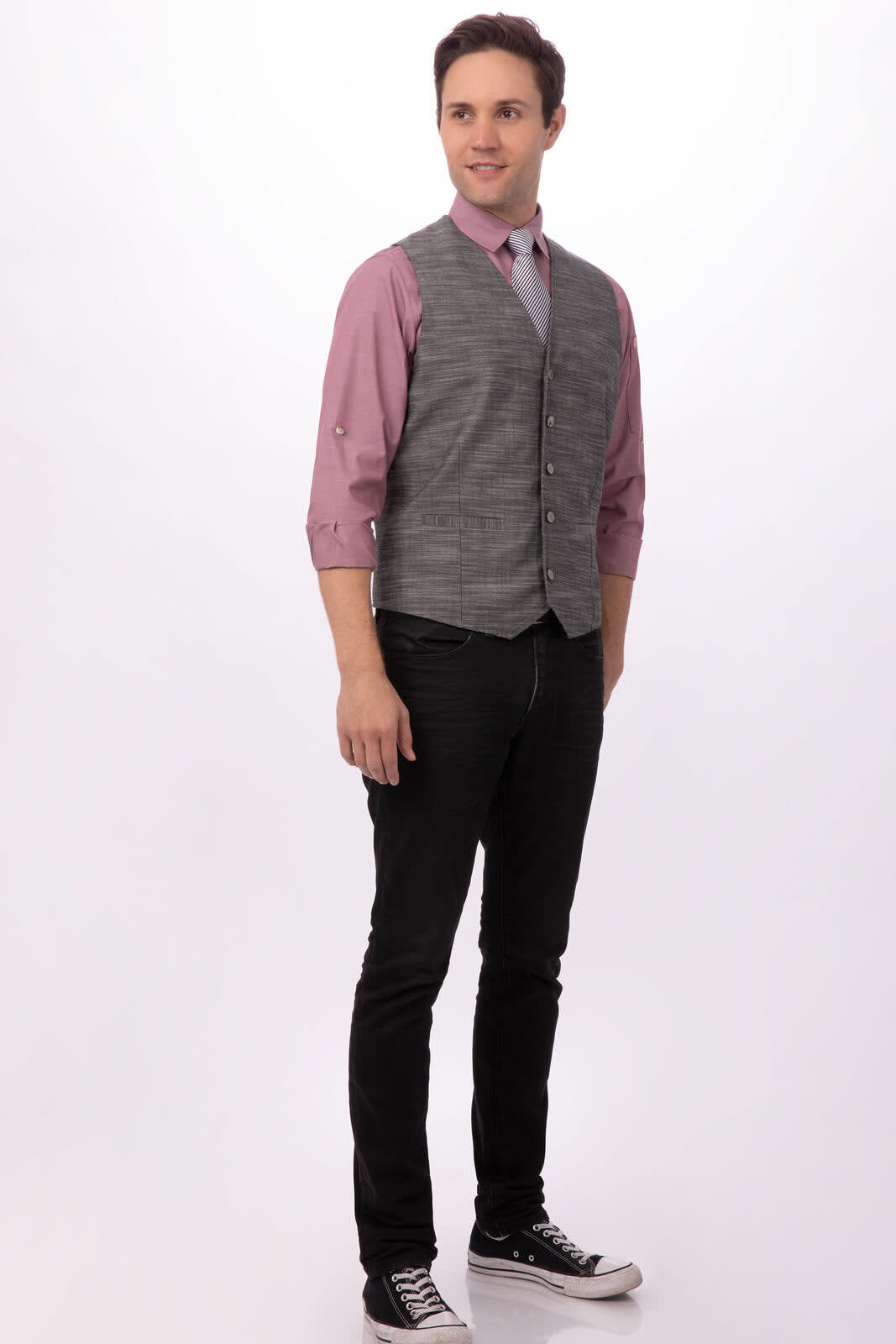 A grey men's vest paired with a pink shirt and black jeans, with a man wearing sneakers and a confident pose.