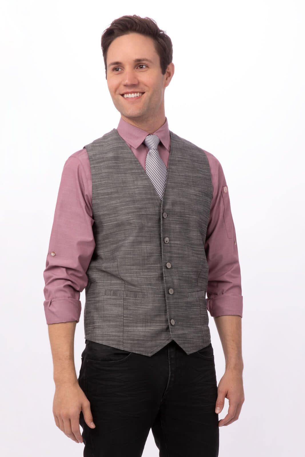 A grey patterned men's vest worn over a light pink shirt, featuring a slim fit and buttons. The model is smiling.