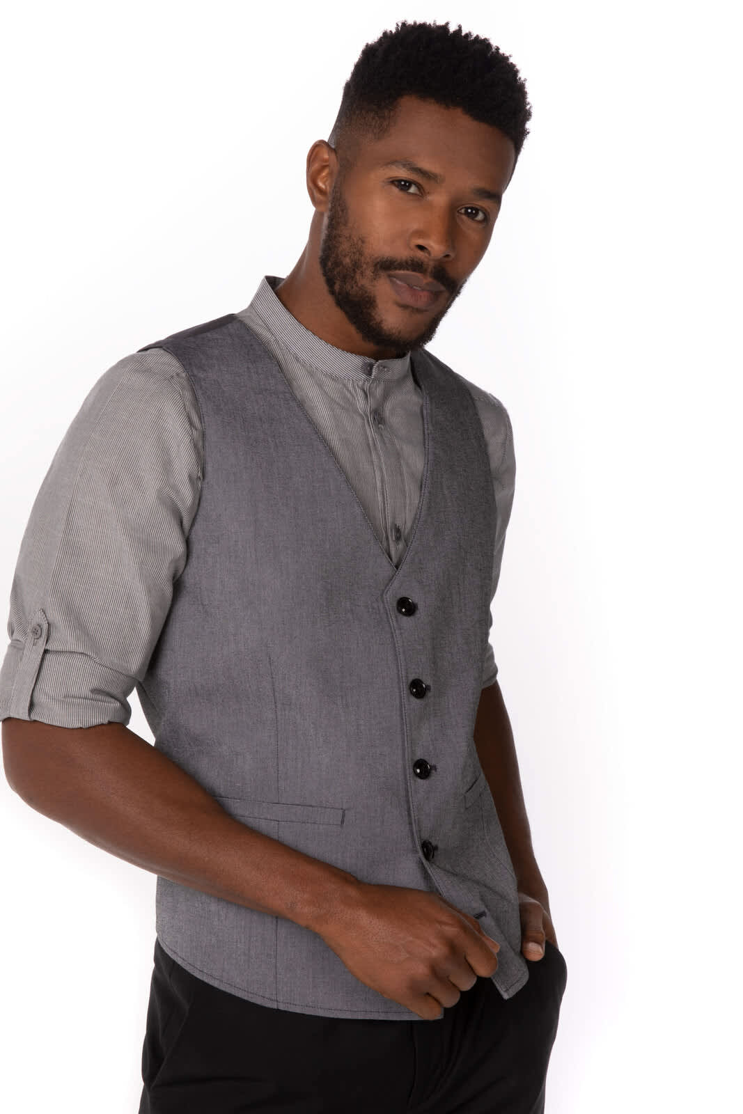 A grey men's vest featuring a formal design, displayed by a model wearing a collared shirt underneath.