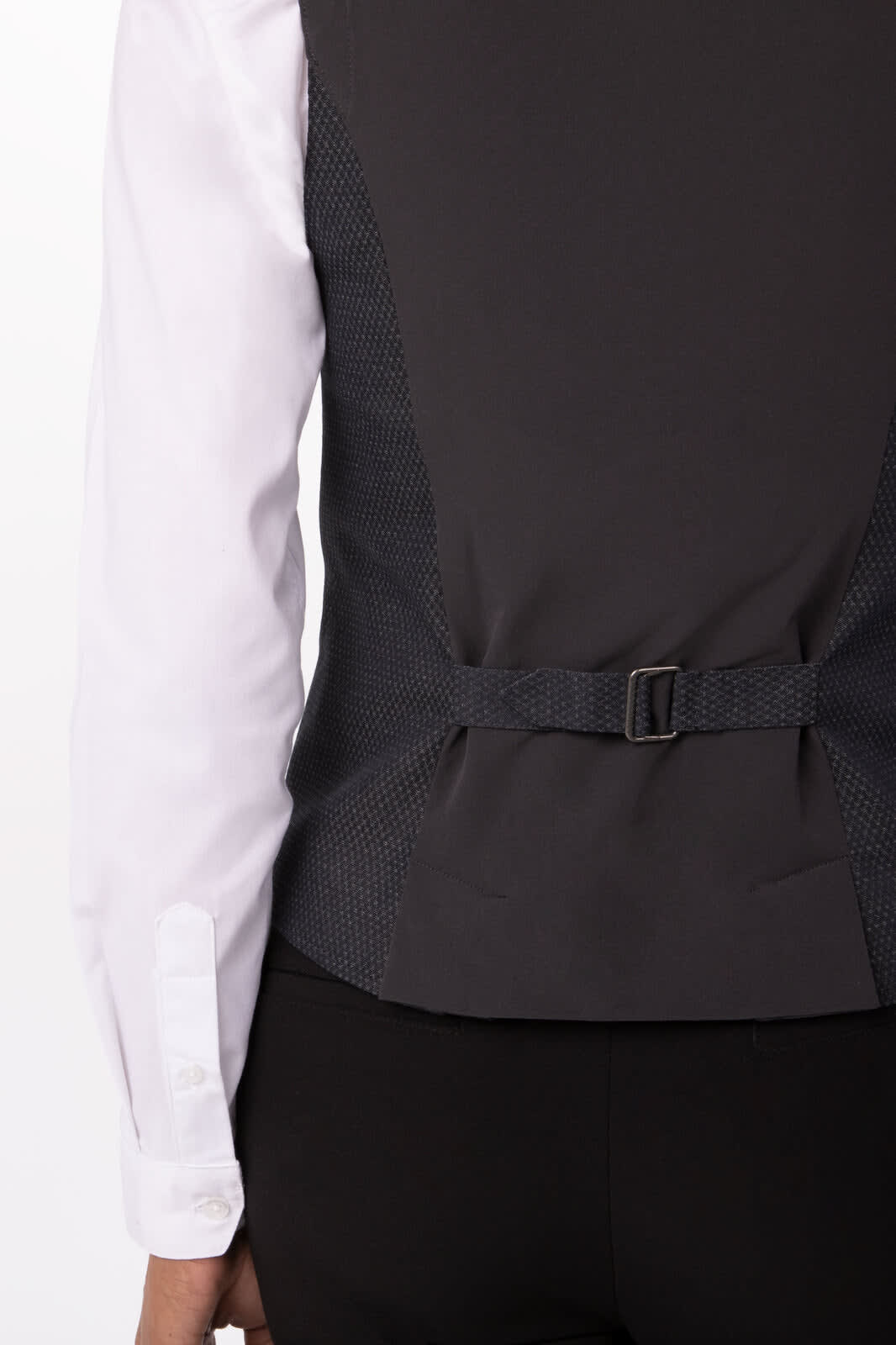 A dark grey women's vest with a patterned back and a buckle detail, worn over a white shirt.