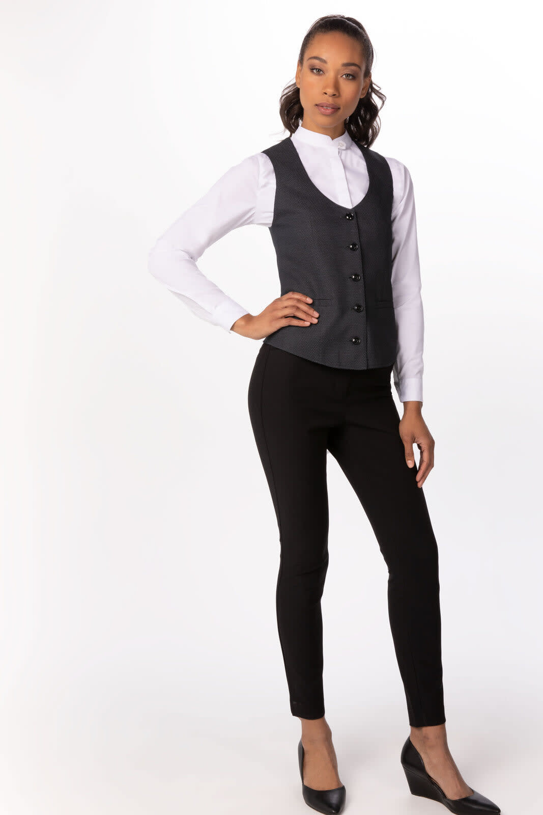 A tailored women's vest in dark grey, paired with a white shirt and black trousers, featuring a logo.