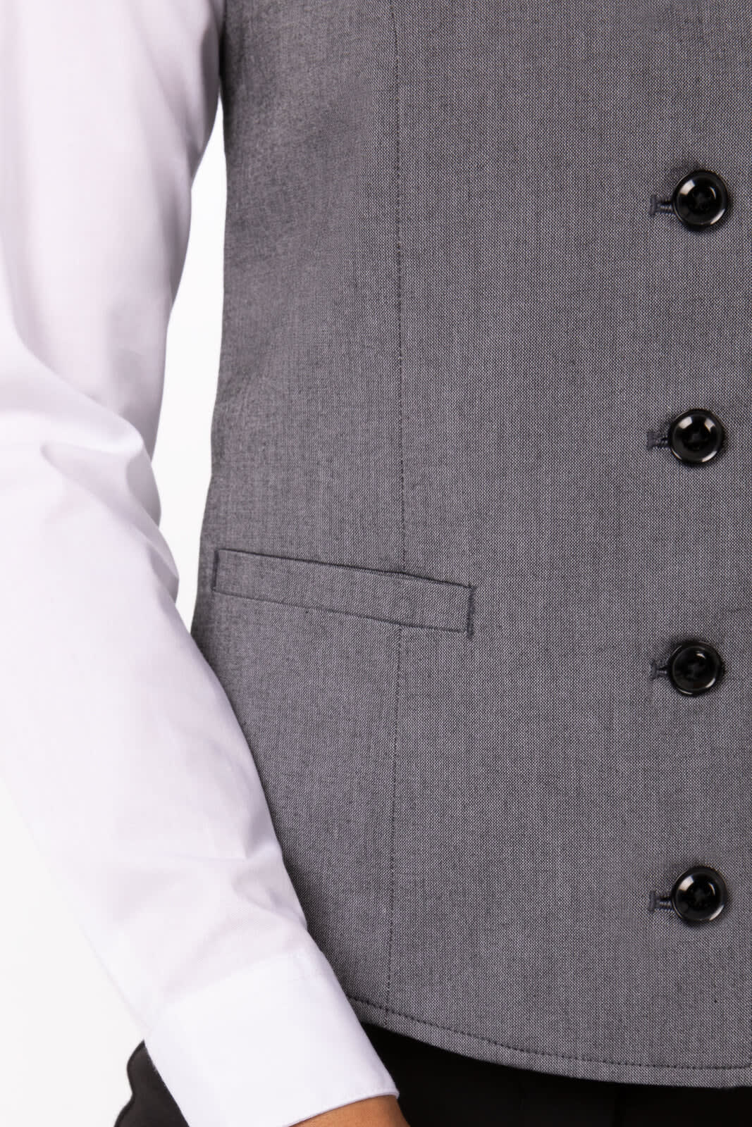A grey women's vest with a tailored fit, featuring black buttons and a side pocket.