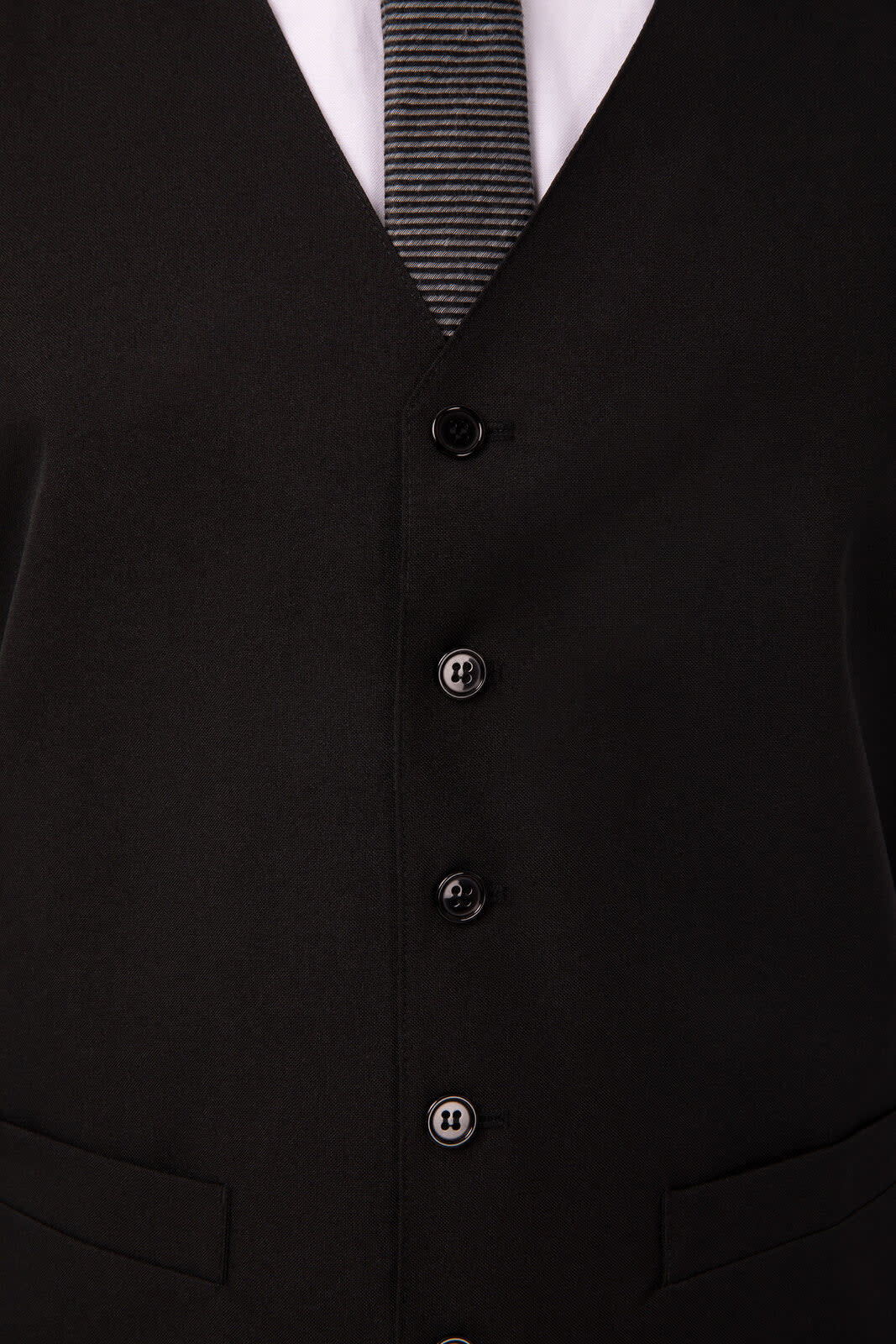 A black men's vest featuring a classic design with buttons and side pockets, accompanied by a striped tie.