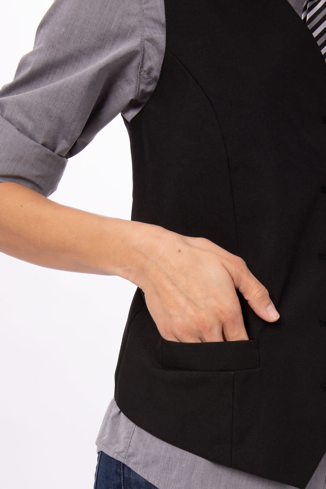 A black women's vest with a fitted design, featuring a hand in the side pocket, worn over a grey shirt.