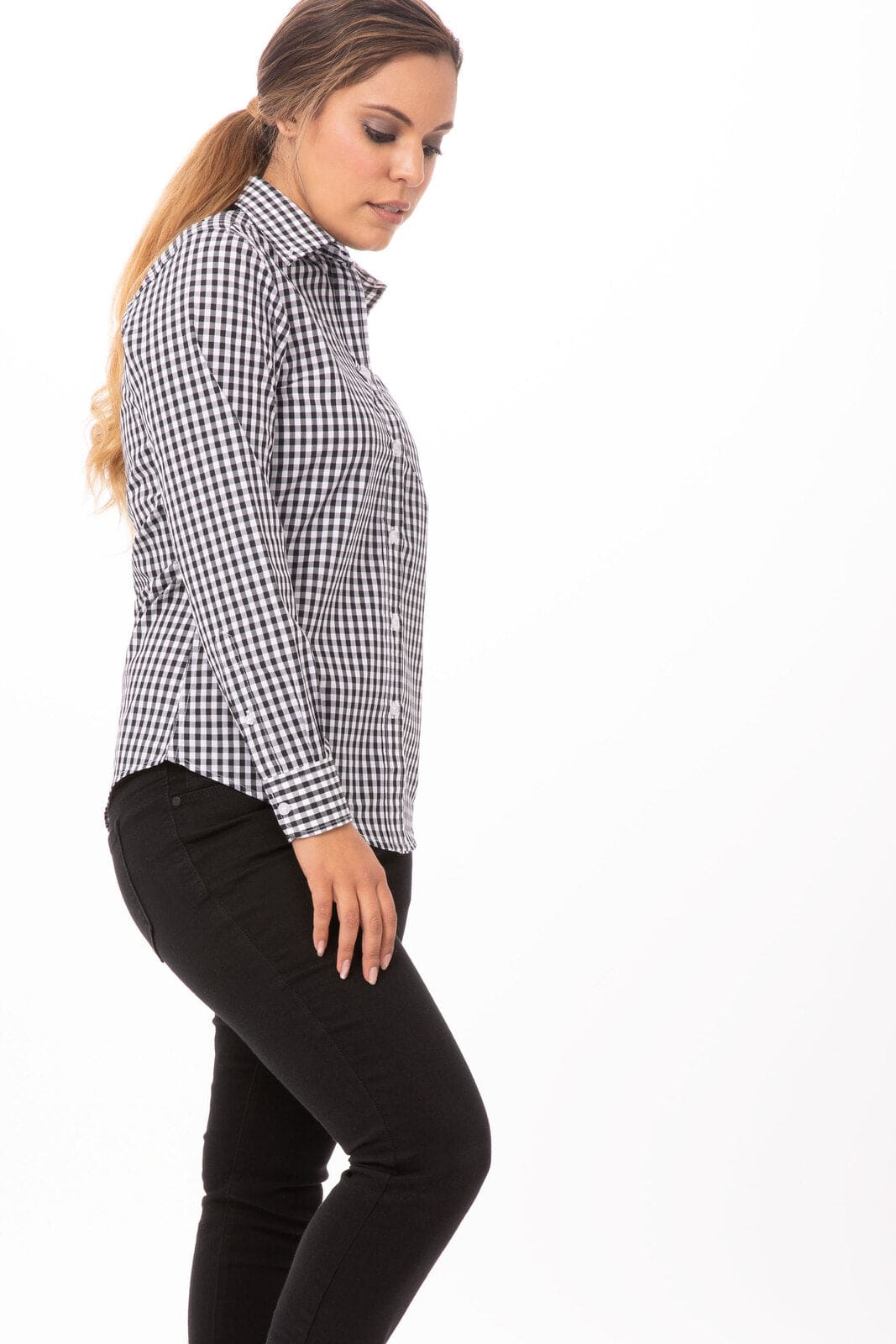 A women's button-up gingham dress shirt in black and white, displayed on a model with long hair and black pants.