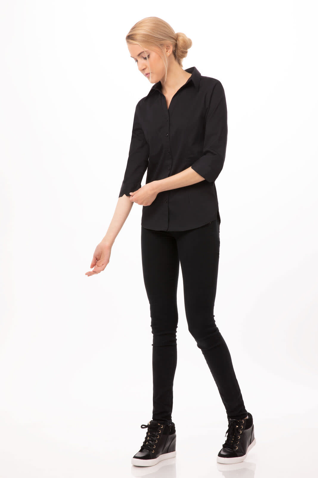 A black button-up women's shirt with three-quarter sleeves, paired with black skinny jeans and sneakers.