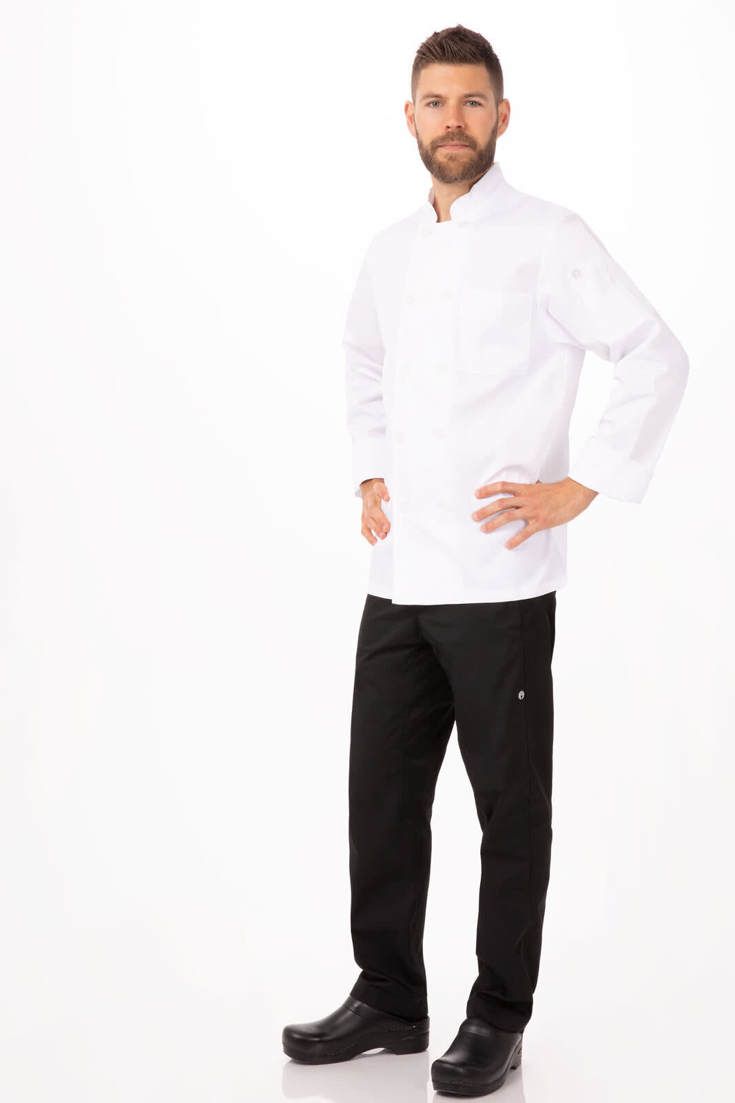 A men's chef jacket in white, paired with black chef pants, modelled by a man standing confidently.