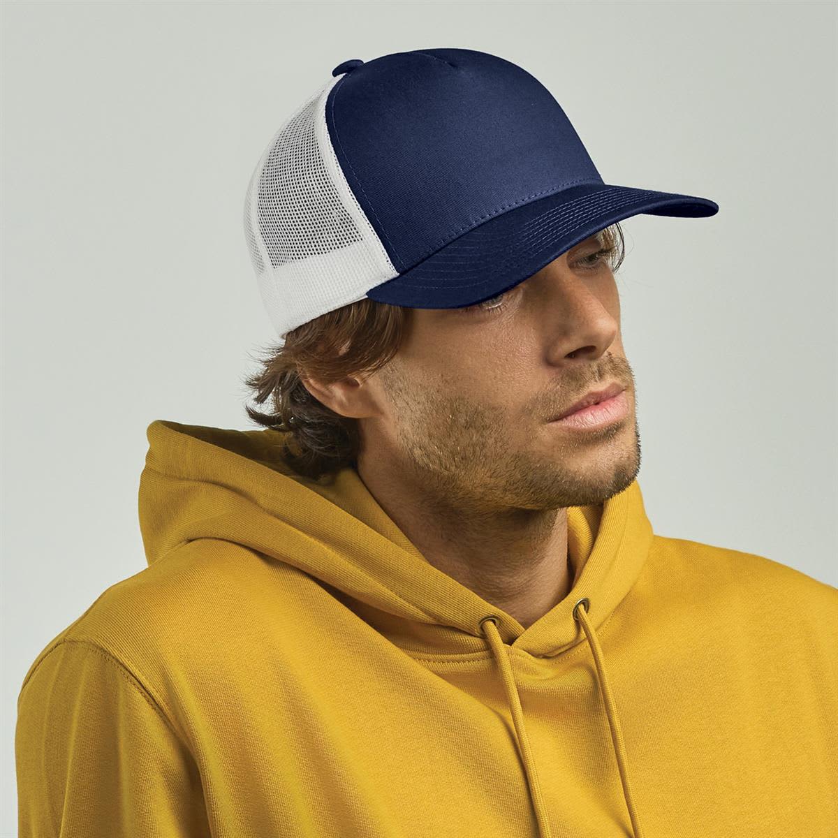 Record Trucker LE-A2000 A navy blue and white trucker cap worn by a man in a yellow hoodie, featuring a logo on the front.