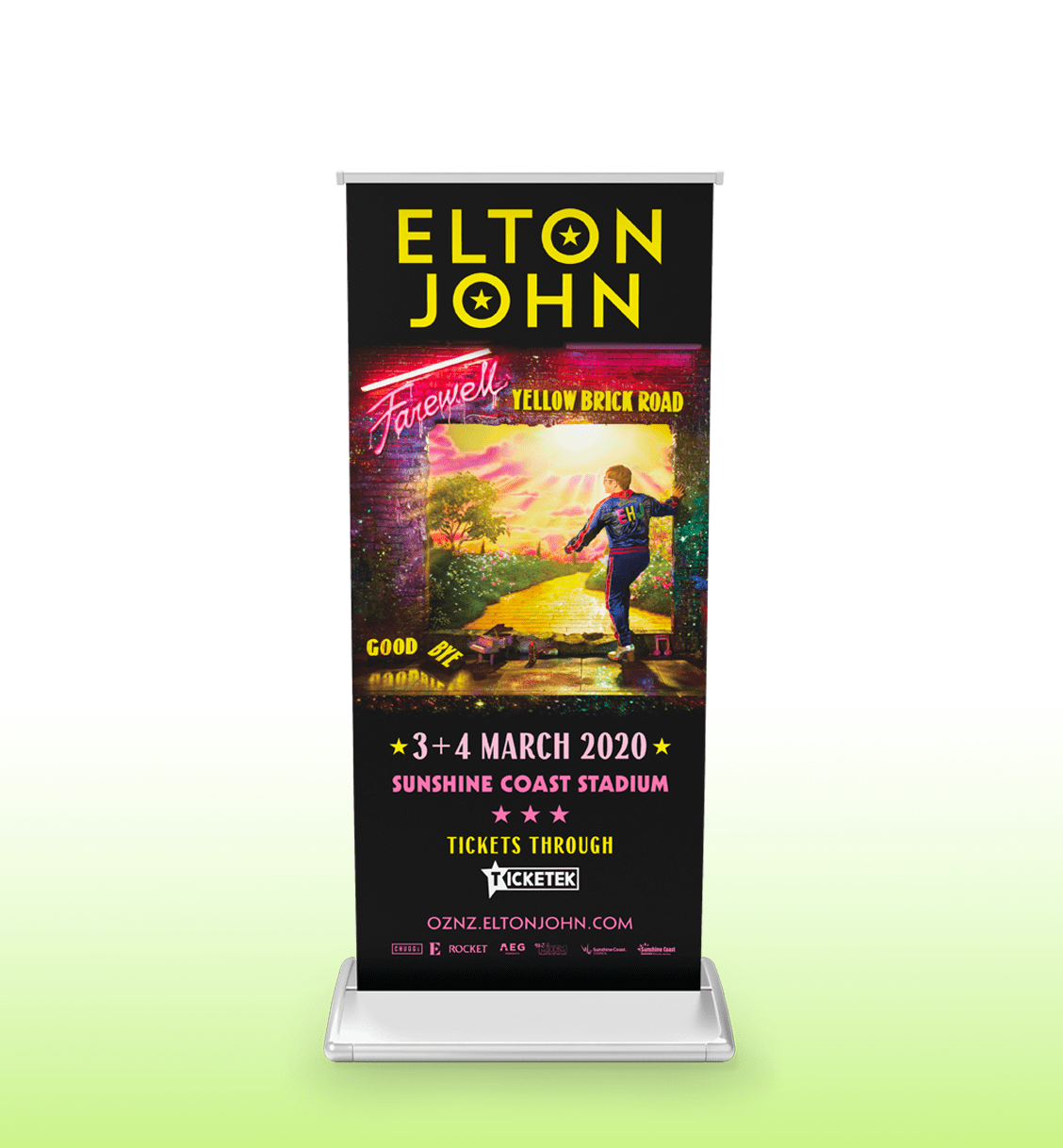 A pull-up banner featuring a vibrant design, predominantly black and yellow, promoting Elton John's Farewell Yellow Brick Road tour.