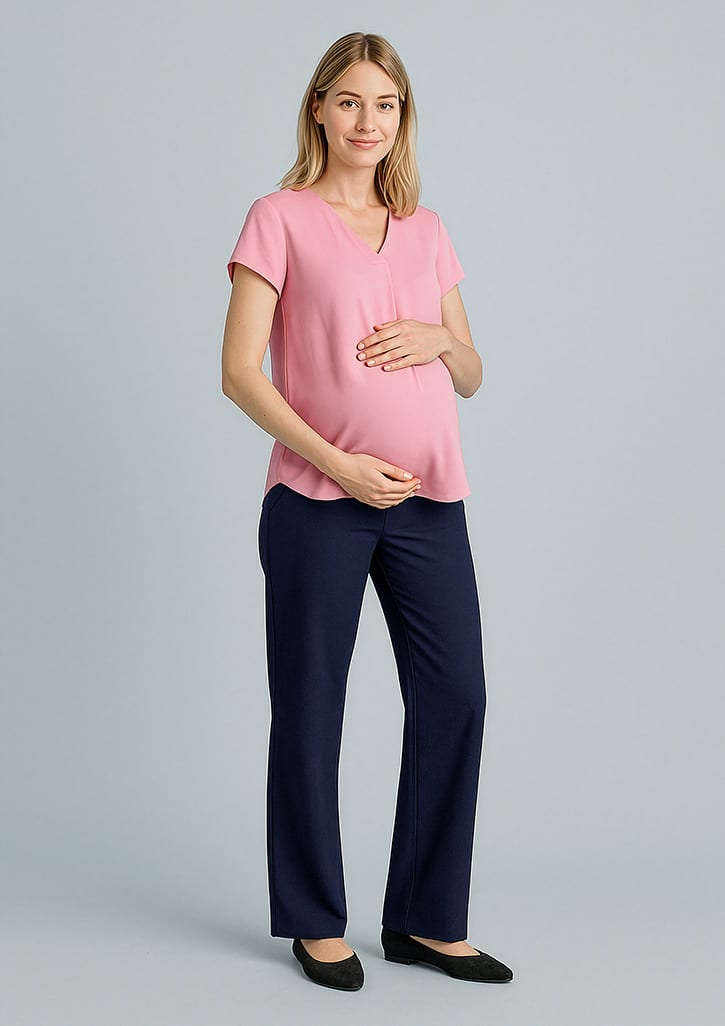 A maternity pant in navy blue, paired with a pink top, worn by a pregnant model. Features a logo.
