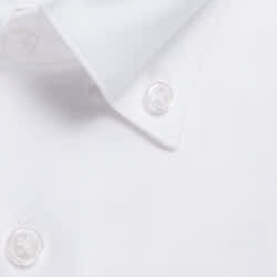 A close-up of a white button-up shirt featuring clear buttons and a classic collar.