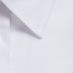 A close-up of a white button-up shirt collar featuring a logo.