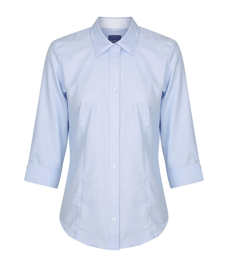 A light blue button-up shirt with three-quarter sleeves and a collar. It features a logo on the chest area.