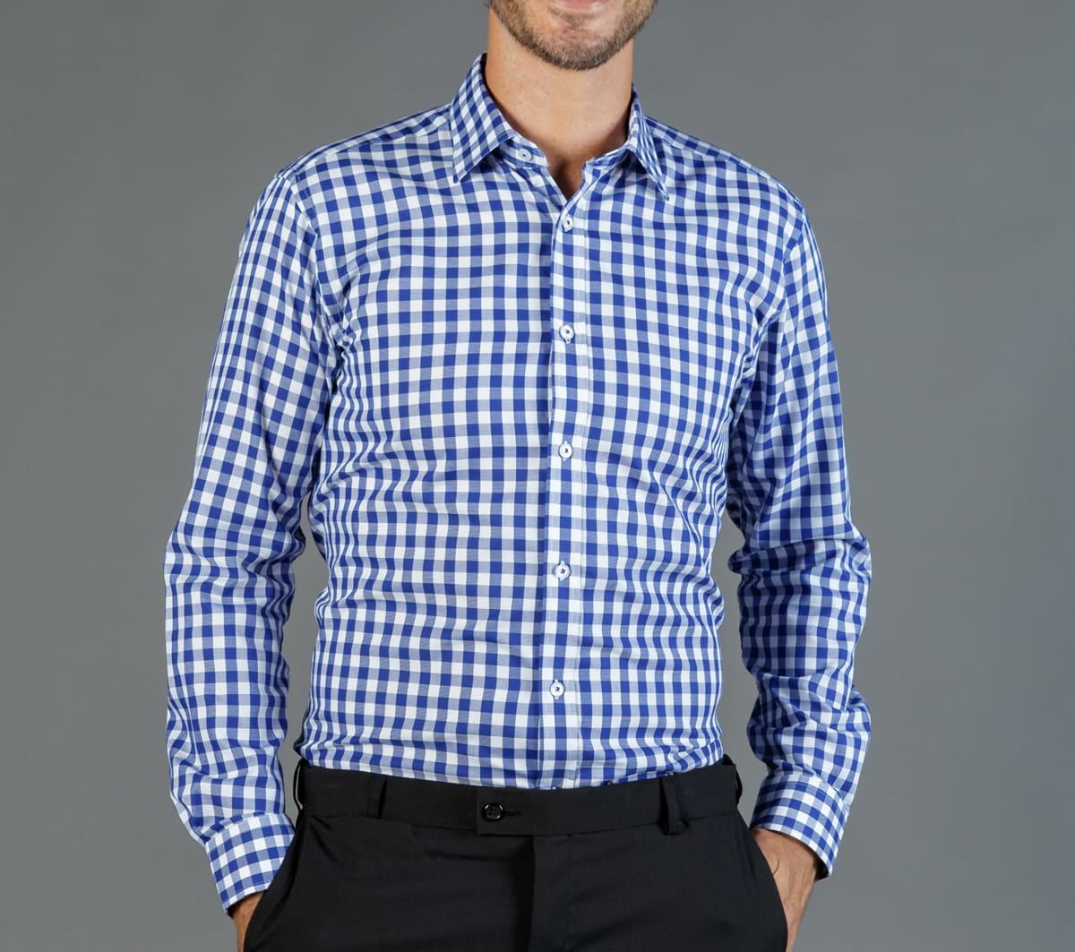 A button-up shirt featuring a blue and white gingham pattern, with a fitted design and long sleeves.