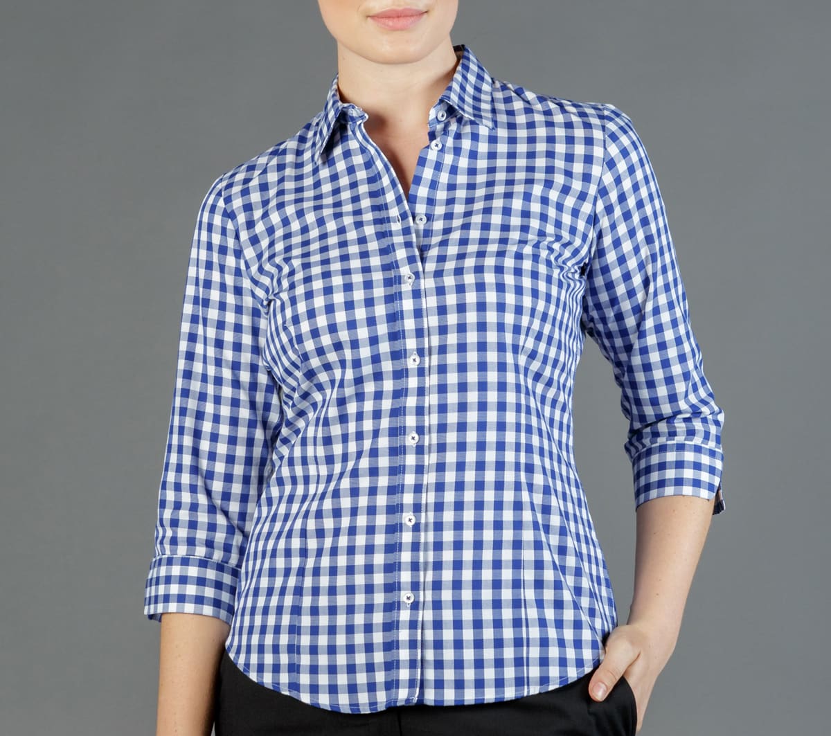 A button-up shirt featuring a blue and white gingham pattern, with rolled-up sleeves and a collar.