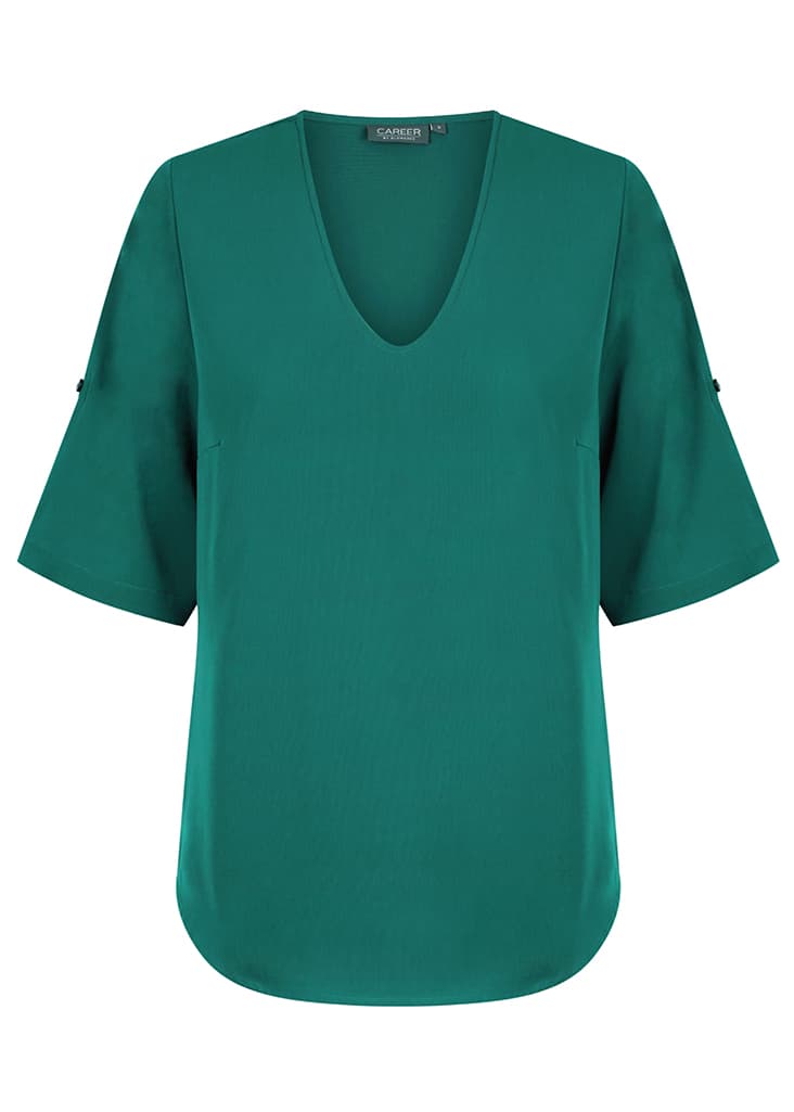 A green v-neck shirt with short sleeves and a rounded hem, featuring a logo on the label.